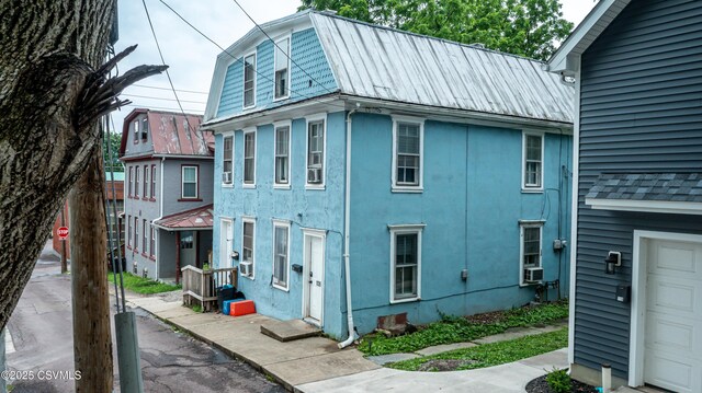 126-128 Murray Ave, Bloomsburg, PA 17815 - view of side of home with a metal roof, stucco siding, and cooling unit