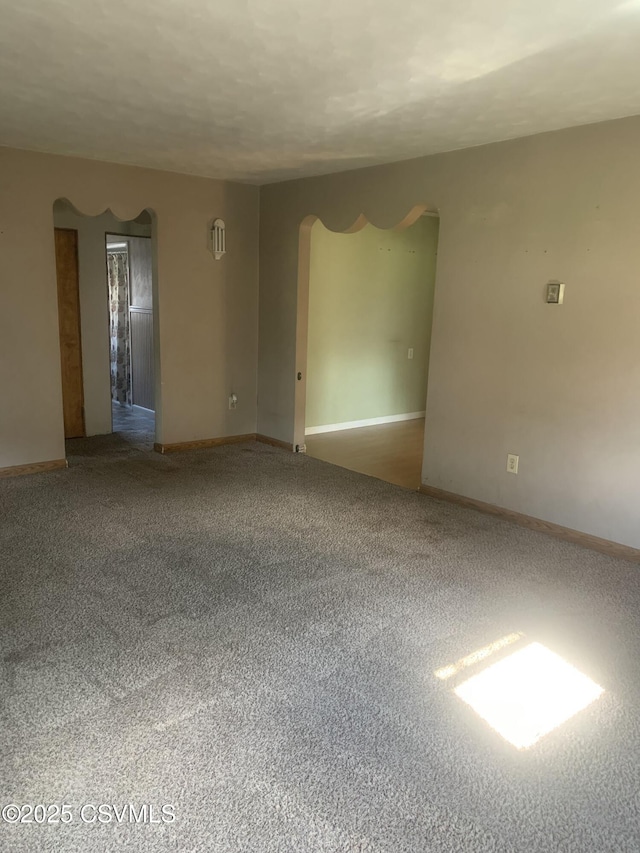 1542 1st Ave, Berwick, PA 18603 - carpeted empty room with arched walkways and baseboards
