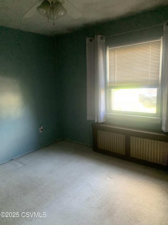 1542 1st Ave, Berwick, PA 18603 - unfurnished room featuring radiator, carpet floors, and ceiling fan