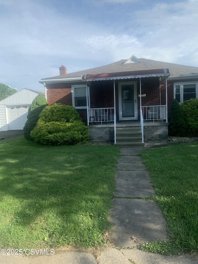 1542 1st Ave, Berwick, PA 18603 - single story home with brick siding, a chimney, a front yard, covered porch, and a shingled roof