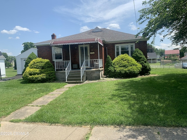1542 1st Ave, Berwick, PA 18603 - view of front facade with brick siding, covered porch, a chimney, and roof with shingles