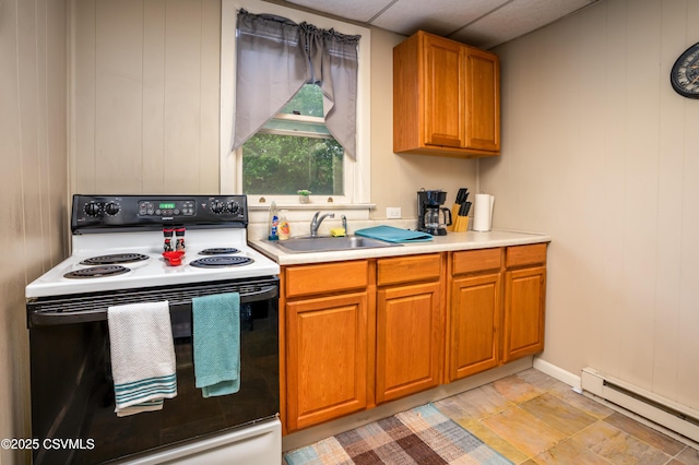 846-848 Orange St, Berwick, PA 18603 - kitchen with white range with electric cooktop, a baseboard heating unit, light countertops, brown cabinets, and a paneled ceiling