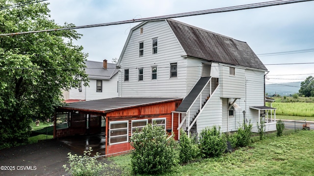 846-848 Orange St, Berwick, PA 18603 - rear view of house featuring roof with shingles and a lawn