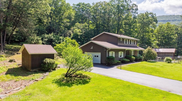 39 Mckendree Rd, Shickshinny, PA 18655 - view of front of house with a front lawn, a garage, a storage shed, and asphalt driveway