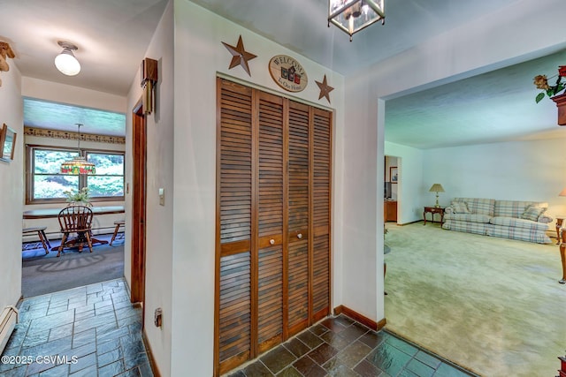 39 Mckendree Rd, Shickshinny, PA 18655 - hall with dark carpet, stone tile flooring, a chandelier, and a baseboard radiator