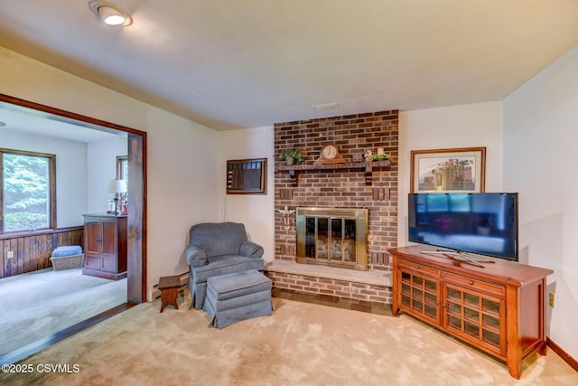 39 Mckendree Rd, Shickshinny, PA 18655 - living area with a brick fireplace, carpet, and a wainscoted wall