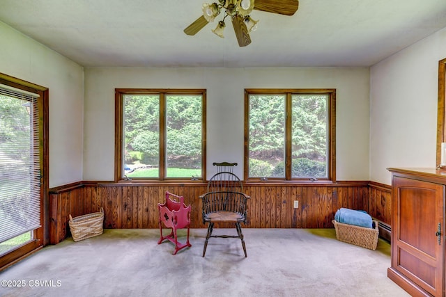 39 Mckendree Rd, Shickshinny, PA 18655 - living area with carpet floors, a wainscoted wall, wooden walls, ceiling fan, and a baseboard radiator