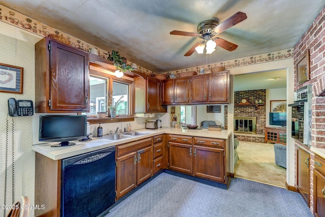 39 Mckendree Rd, Shickshinny, PA 18655 - kitchen with black dishwasher, a fireplace, light carpet, light countertops, and wallpapered walls