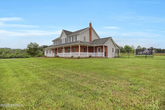 110 Buckeye Ln, New Columbia, PA 17856 - view of front facade with a trampoline, a front lawn, a porch, and a chimney