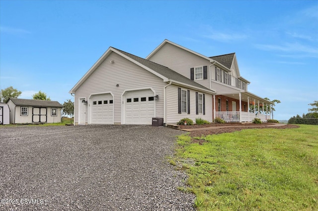 110 Buckeye Ln, New Columbia, PA 17856 - view of front facade with a porch, a storage shed, an attached garage, and driveway