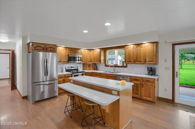 110 Buckeye Ln, New Columbia, PA 17856 - kitchen featuring stainless steel appliances, light countertops, light wood-style floors, a center island, and recessed lighting