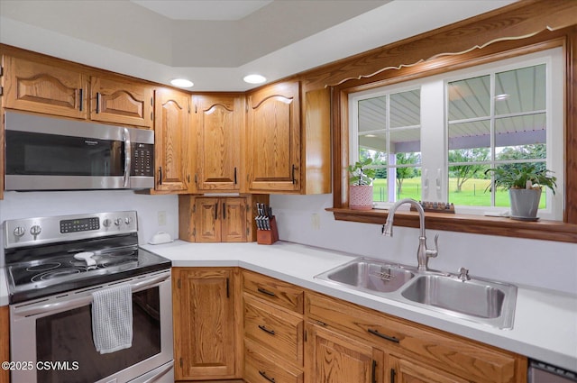 110 Buckeye Ln, New Columbia, PA 17856 - kitchen featuring stainless steel appliances, light countertops, brown cabinets, and recessed lighting