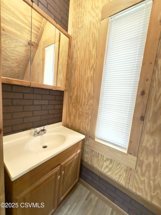 333 E Bowman St, Berwick, PA 18603 - bathroom with wood finished floors, vaulted ceiling, and vanity