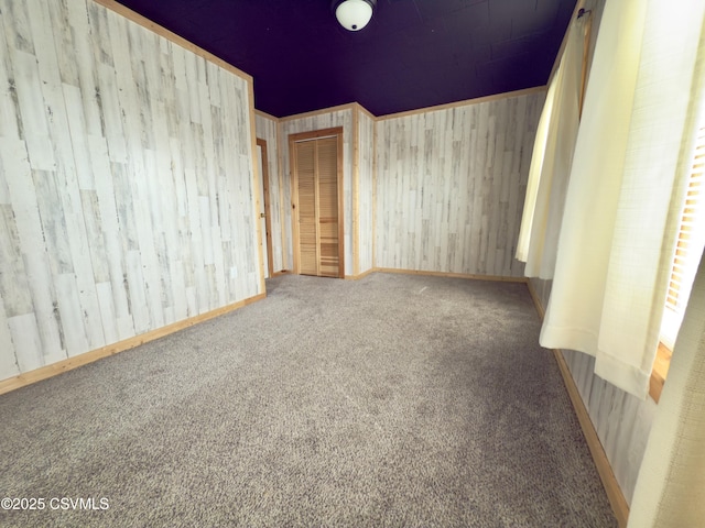333 E Bowman St, Berwick, PA 18603 - unfurnished bedroom with carpet, a closet, and wooden walls