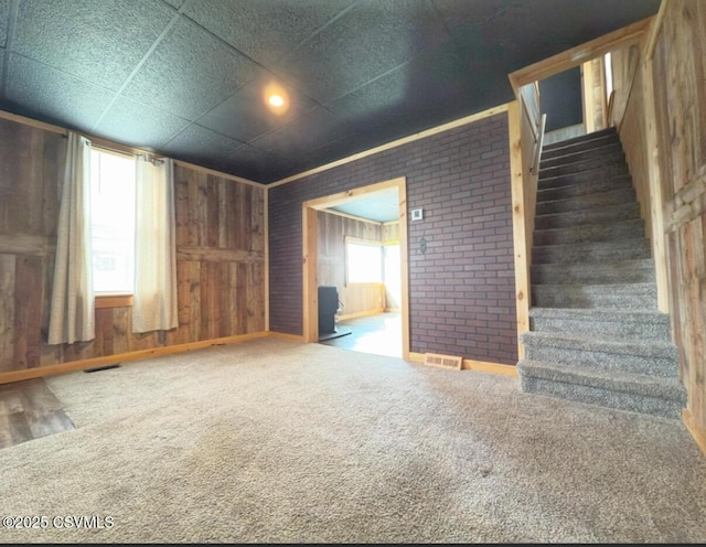 333 E Bowman St, Berwick, PA 18603 - unfurnished living room with stairway, carpet floors, and wooden walls