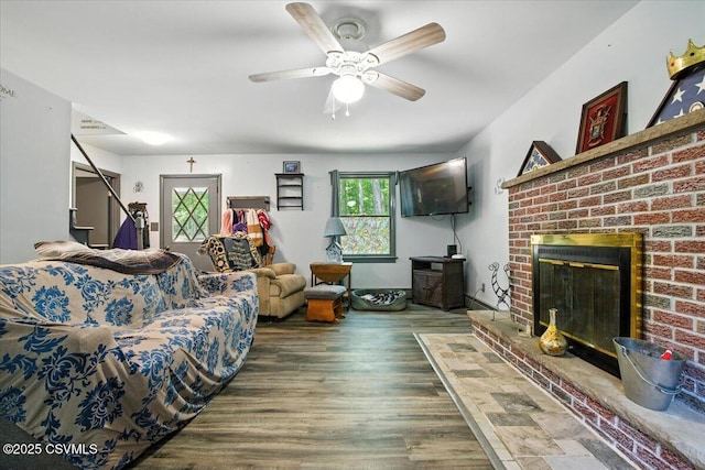 1146 Great Oak Dr, East Stroudsburg, PA 18301 - living room with wood finished floors, stairway, a brick fireplace, and ceiling fan