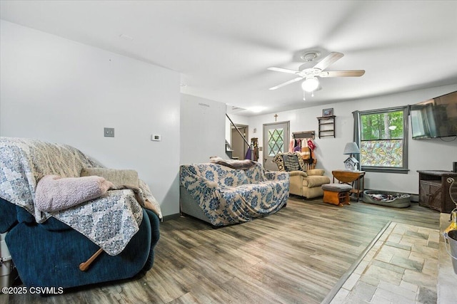 1146 Great Oak Dr, East Stroudsburg, PA 18301 - living area with wood finished floors, ceiling fan, and stairs