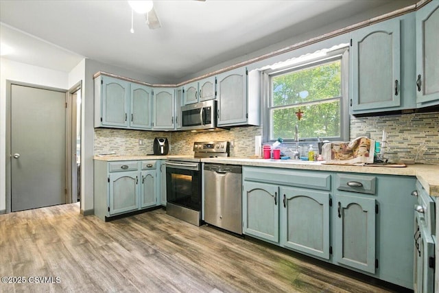 1146 Great Oak Dr, East Stroudsburg, PA 18301 - kitchen with stainless steel appliances, backsplash, dark wood-style flooring, and light countertops