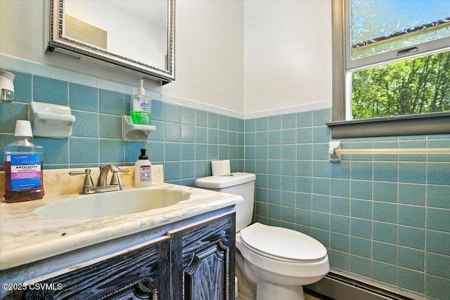 1146 Great Oak Dr, East Stroudsburg, PA 18301 - half bath with baseboard heating, vanity, tile walls, and wainscoting