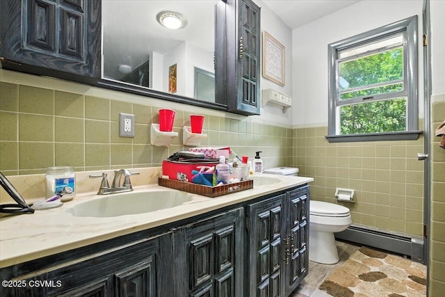 1146 Great Oak Dr, East Stroudsburg, PA 18301 - full bathroom with a baseboard radiator, tile walls, double vanity, and wainscoting
