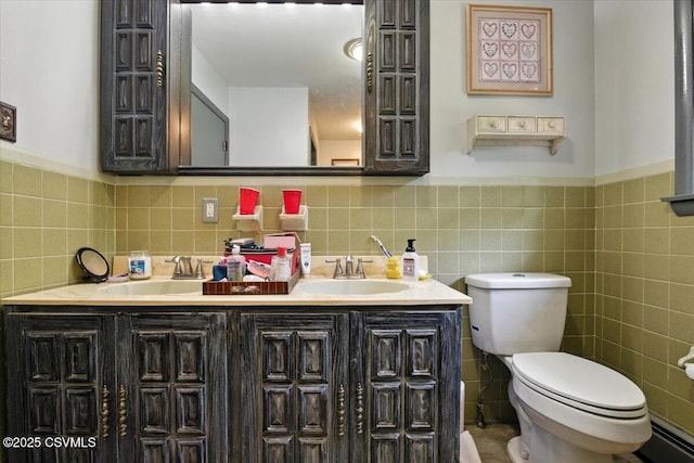 1146 Great Oak Dr, East Stroudsburg, PA 18301 - bathroom with double vanity, tile walls, and wainscoting