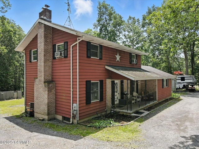 1146 Great Oak Dr, East Stroudsburg, PA 18301 - view of front of house featuring a chimney, covered porch, and cooling unit