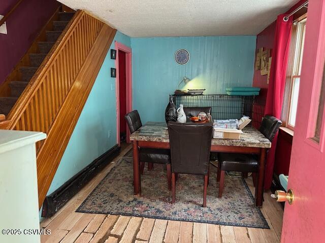 26 Sherman St, Coal Township, PA 17866 - dining area featuring wood finished floors, stairs, and a textured ceiling