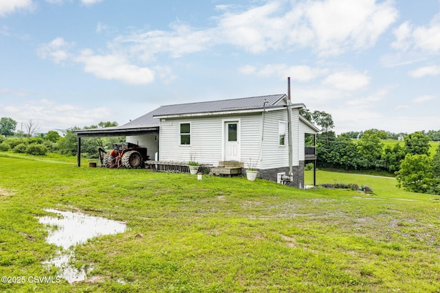 190 Foggy Mountain Rd, Turbotville, PA 17772 - rear view of property with a lawn, entry steps, a carport, and a metal roof