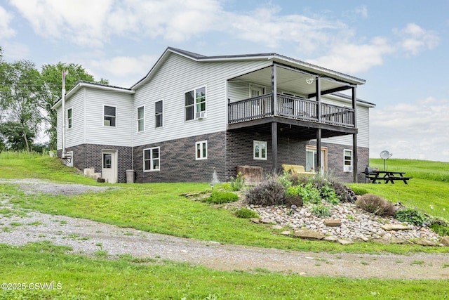 190 Foggy Mountain Rd, Turbotville, PA 17772 - view of property exterior with a balcony, brick siding, and a lawn