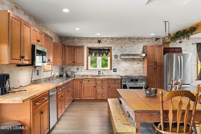 190 Foggy Mountain Rd, Turbotville, PA 17772 - kitchen with appliances with stainless steel finishes, butcher block counters, light wood-style flooring, recessed lighting, and brown cabinetry