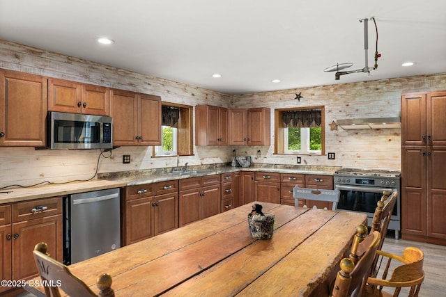190 Foggy Mountain Rd, Turbotville, PA 17772 - kitchen featuring appliances with stainless steel finishes, recessed lighting, wood finished floors, brown cabinetry, and exhaust hood