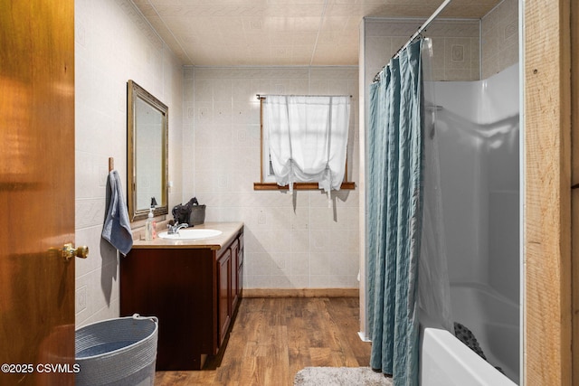 190 Foggy Mountain Rd, Turbotville, PA 17772 - bathroom featuring wood finished floors, vanity, tile walls, and shower / bathtub combination with curtain