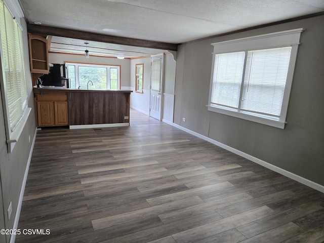1824 Smalsh Barrick Rd, Middleburg, PA 17842 - unfurnished living room featuring dark wood-type flooring, a textured ceiling, and beam ceiling