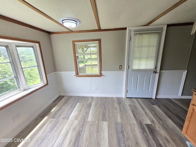 1824 Smalsh Barrick Rd, Middleburg, PA 17842 - spare room featuring a textured ceiling, healthy amount of natural light, wood finished floors, and a wainscoted wall