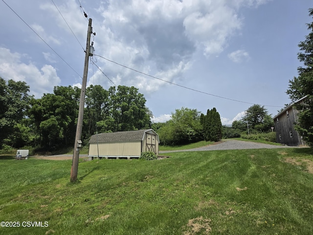 1824 Smalsh Barrick Rd, Middleburg, PA 17842 - view of grassy yard featuring a storage shed and gravel driveway