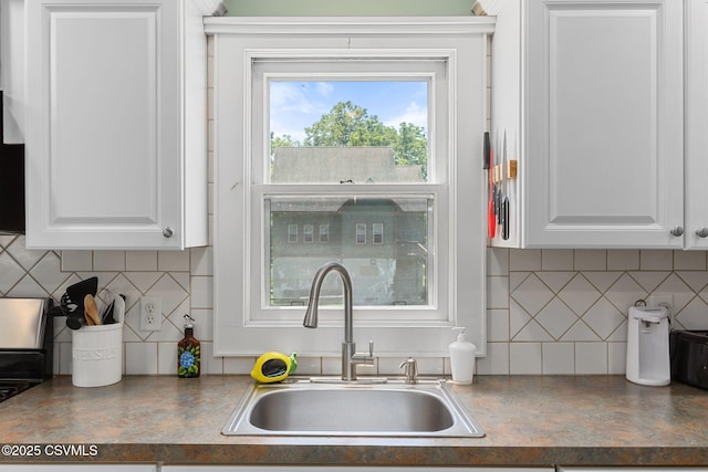 378 Drinker St, Bloomsburg, PA 17815 - kitchen featuring decorative backsplash, white cabinetry, and dark countertops