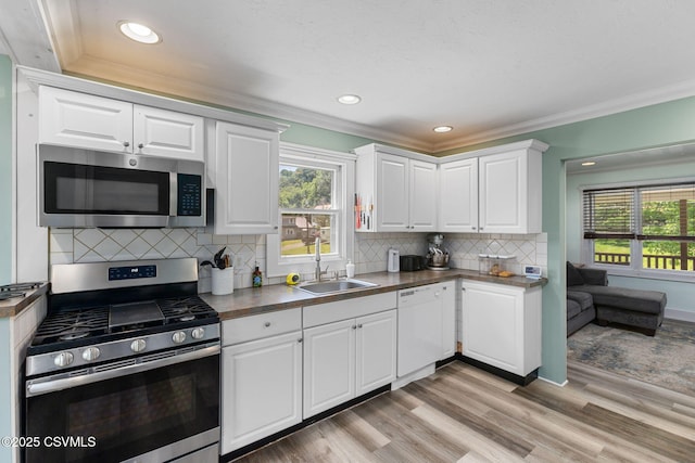 378 Drinker St, Bloomsburg, PA 17815 - kitchen featuring appliances with stainless steel finishes, ornamental molding, healthy amount of natural light, white cabinetry, and recessed lighting