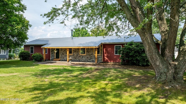 909 Fair St, Nescopeck, PA 18635 - view of front of home featuring a front yard, stone siding, and a metal roof