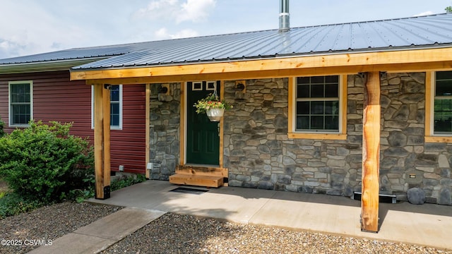 909 Fair St, Nescopeck, PA 18635 - property entrance featuring stone siding and a metal roof