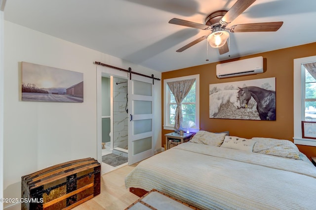 909 Fair St, Nescopeck, PA 18635 - bedroom with an AC wall unit, a barn door, ensuite bathroom, and a ceiling fan
