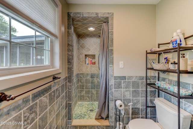 909 Fair St, Nescopeck, PA 18635 - full bathroom featuring tile walls, a tile shower, and wainscoting