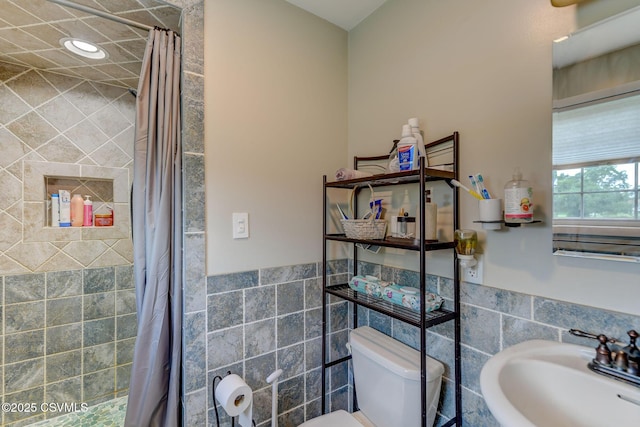 909 Fair St, Nescopeck, PA 18635 - bathroom featuring tile walls, a tile shower, and wainscoting
