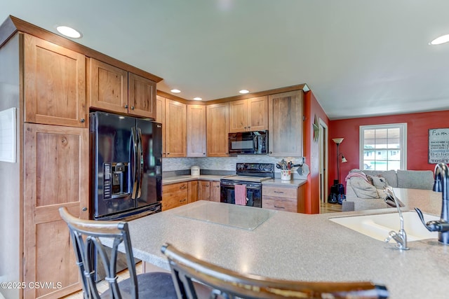 909 Fair St, Nescopeck, PA 18635 - kitchen featuring black appliances, light countertops, backsplash, recessed lighting, and open floor plan