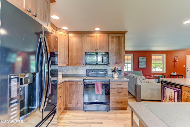909 Fair St, Nescopeck, PA 18635 - kitchen with black appliances, open floor plan, light wood-type flooring, recessed lighting, and backsplash