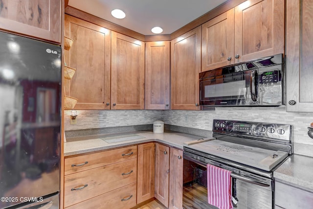 909 Fair St, Nescopeck, PA 18635 - kitchen with black appliances, backsplash, light countertops, and light wood-style floors