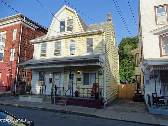 4 N Rock St, Shamokin, PA 17872 - townhome / multi-family property with a porch, a chimney, a shingled roof, and cooling unit