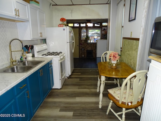 4 N Rock St, Shamokin, PA 17872 - kitchen featuring white gas range, blue cabinets, dark wood-type flooring, light countertops, and white cabinets