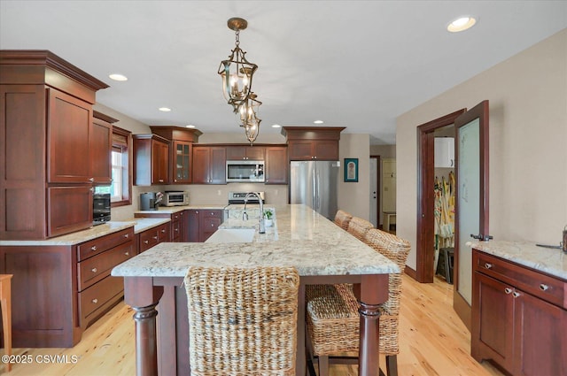 68 Yearling Ln, New Columbia, PA 17856 - kitchen featuring appliances with stainless steel finishes, light wood-type flooring, a breakfast bar area, hanging light fixtures, and recessed lighting