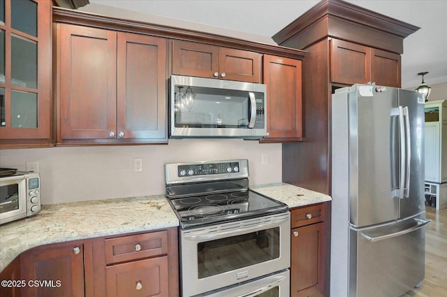 68 Yearling Ln, New Columbia, PA 17856 - kitchen with stainless steel appliances, glass insert cabinets, light stone countertops, and light wood finished floors