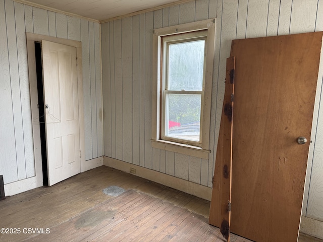 615 Broad St, Berwick, PA 18603 - spare room with wood-type flooring, wooden walls, and healthy amount of natural light